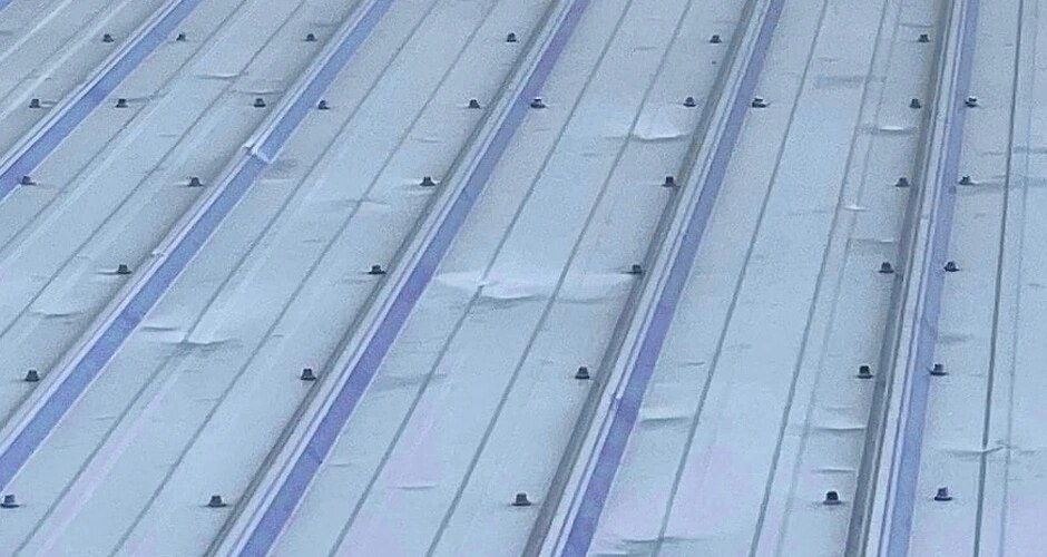 Hail damage on standing seam metal roof - denting across panels