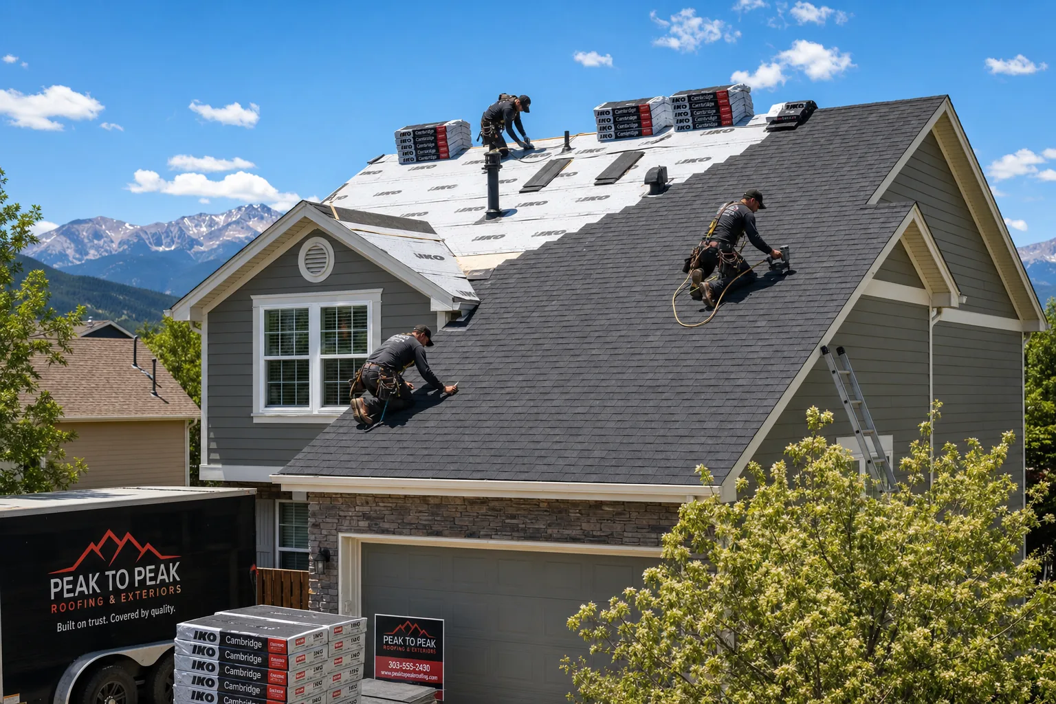 Residential roofing crew installing shingles on Colorado home
